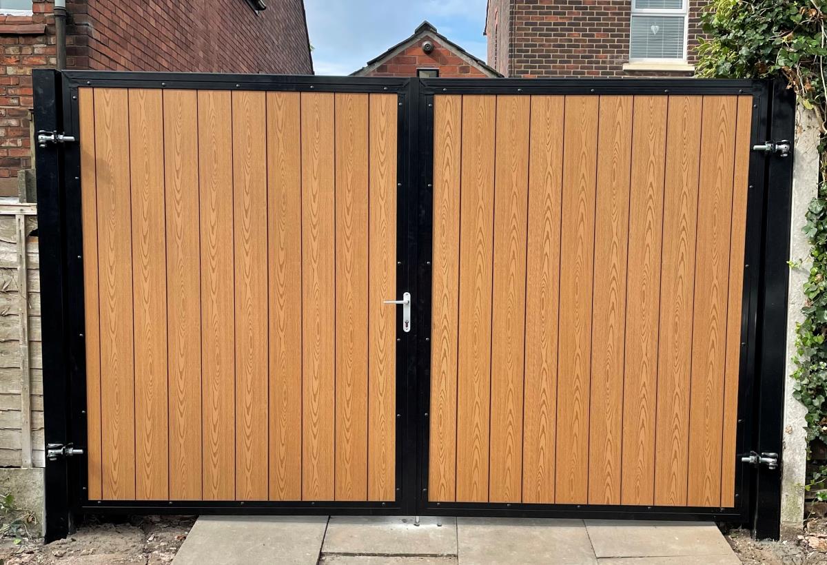 Arched composite gate with embossed timber infill fitted to alley of property in the Altrincham area.