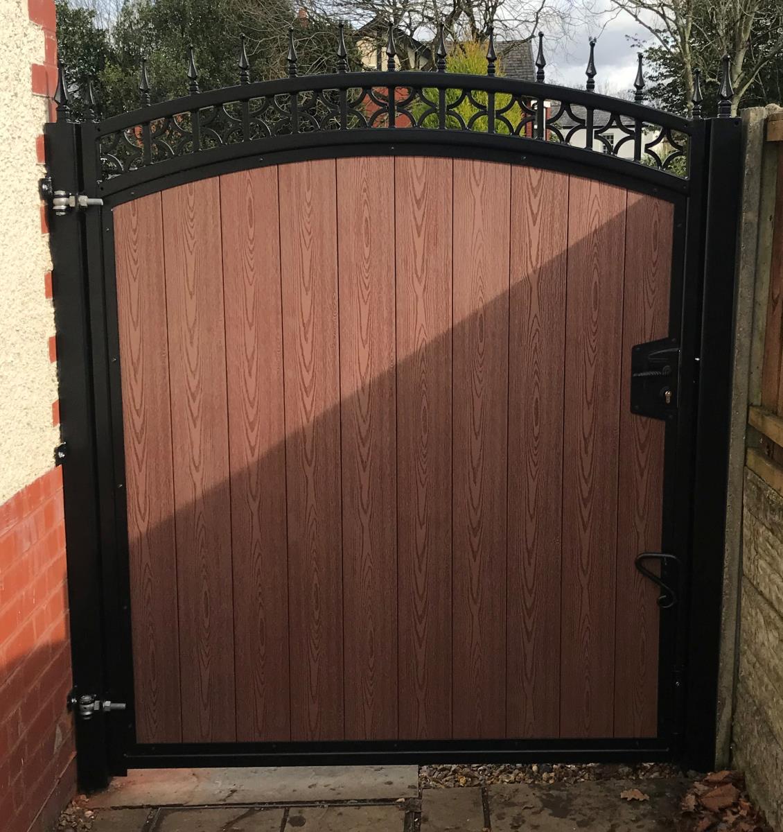 Ornate steel framed timber effect composite gate installation for a property in the Altrincham area.