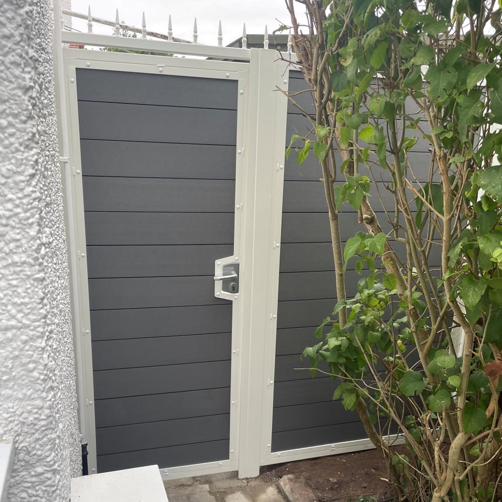 White steel frame side gate and matching panel with grey sanded infill composite fitted in West Kirby, Wirral.